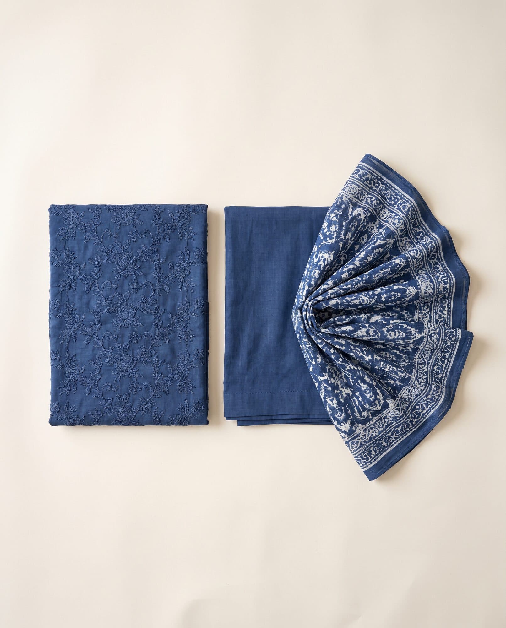 Embroidered lawn 3 piece in indigo laid out flat with printed dupatta