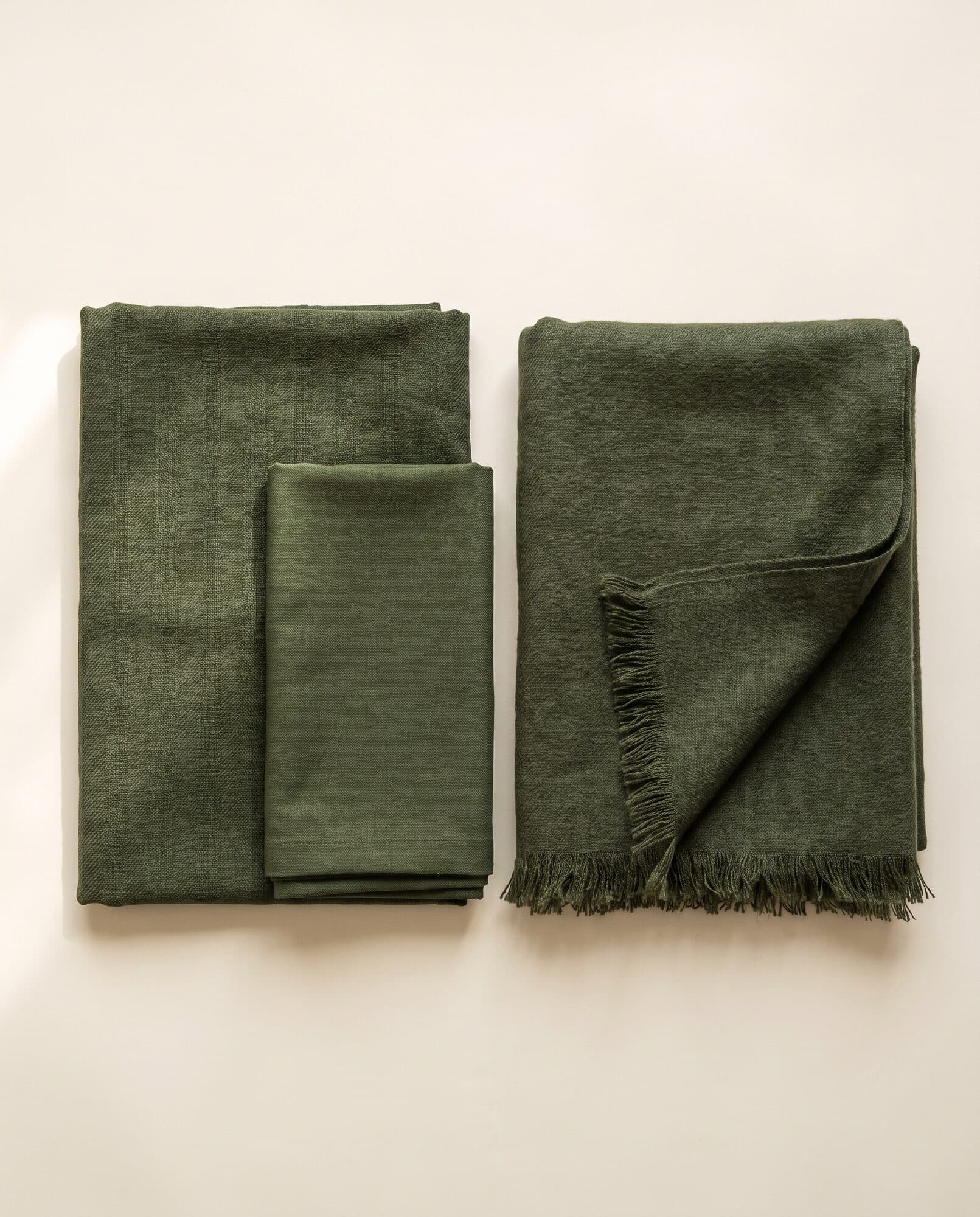 Moss green khaddar 3 piece winter suit laid flat with fringed shawl